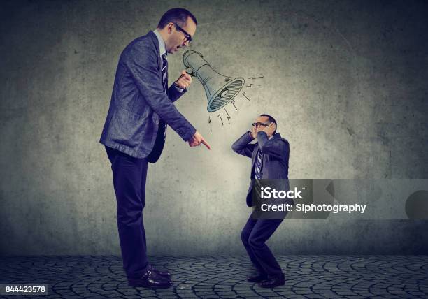 Angry Business Man Boss Screaming At Himself Small In Megaphone Stock Photo - Download Image Now