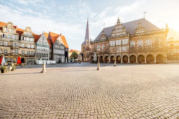View on the Market square with city hall, old church and beautiful buildings during the morning light in Bremen city, Germany