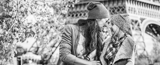 Autumn getaways in Paris with family. Portrait of smiling mother and child travellers on embankment near Eiffel tower in Paris, France having fun time