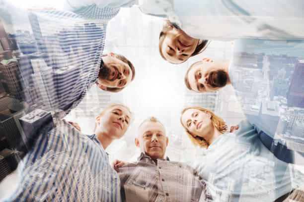 istock Low angle of a friendly team of office workers bonding to each other 844425402