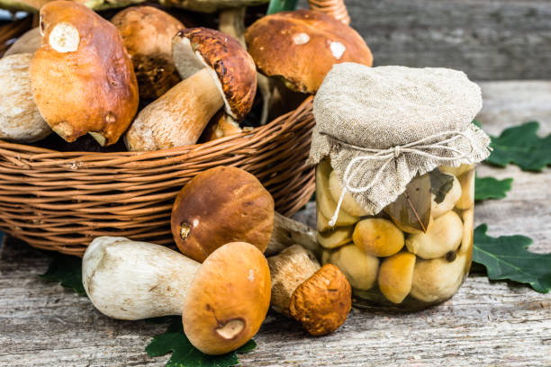 istock Boletus mushrooms marinated in jar on rustic wooden table, autumnal preserves preparing 844425800