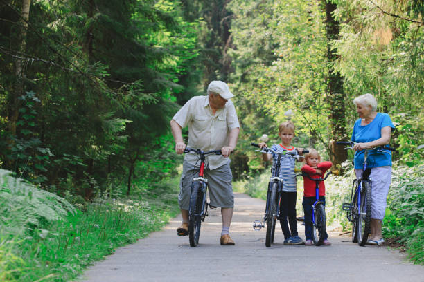 istock active senior couple with kids riding bikes in nature 844426434