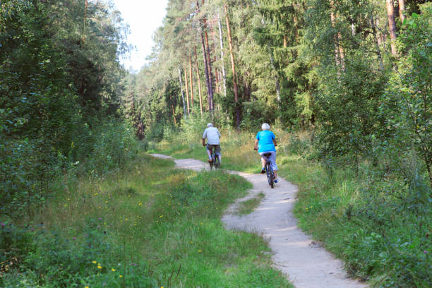 istock active senior couple riding bikes in nature 844426848