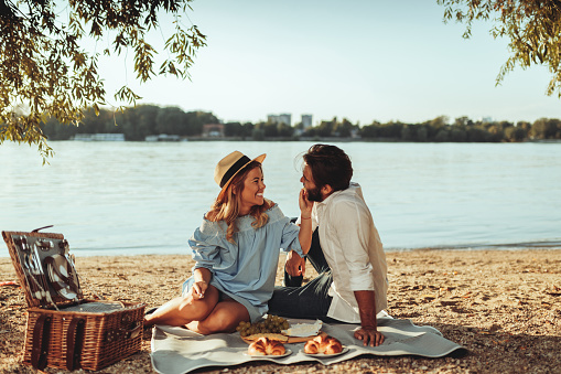 Full length portrait of young couple having good times on a picnic date.