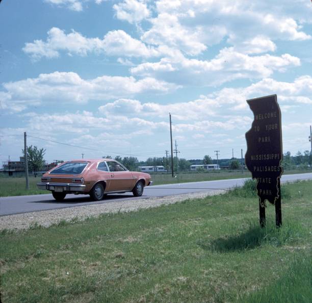 State of Mississippi, USA, 1974. Highway with car and road sign.