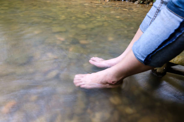 istock Lady feet steep  into the stream 844440948