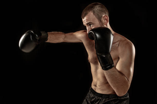 istock The young man kickboxing on black 844443912