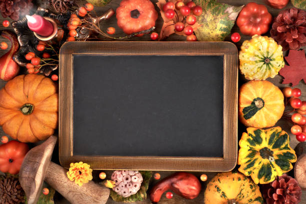 istock Blackboard framed with Autumn decorations on wood, space 844444952