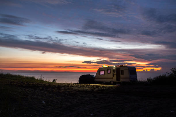 camping, mobile home on the beach, green grass, twilight