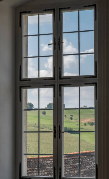 istock Ancient glass window with panoramic view over green hills 844447870