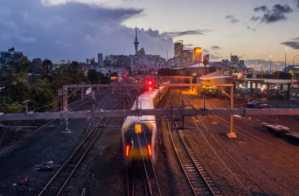 Railway crossing in Auckland with City in Background.