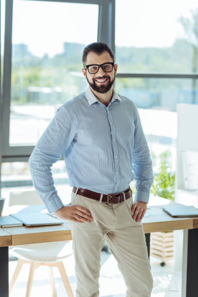 istock Handsome young businessman standing in his new office 844451890