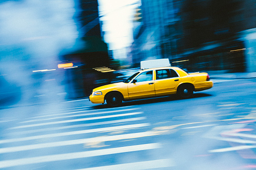 Yellow cab with panning motion in Manhattan, New York City