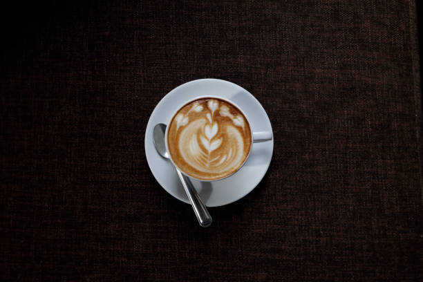istock coffee latte art style with flower picture in white ceramic cup 844458452