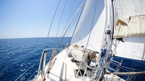 A sailingyacht runs on sunny day through the mediterranean sea