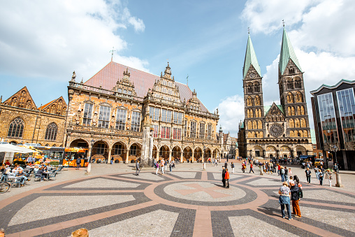 BREMEN, GERMANY - August 09, 2017: View on the Market square full of tourists with beautiful city hall building and saint Peter cathedral during the sunny weather in Bremen, Germany