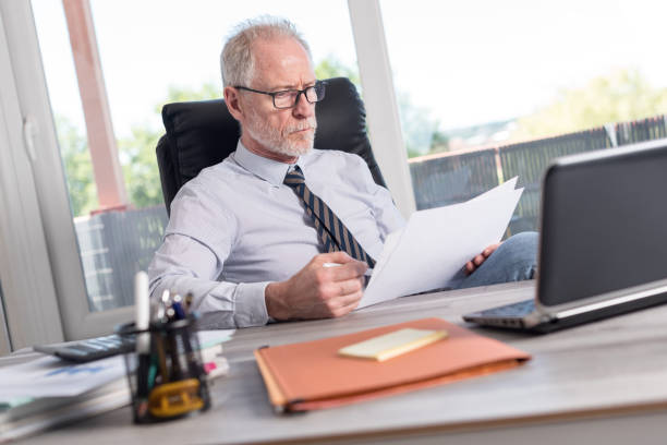 istock Portrait of mature businessman checking documents 844466324