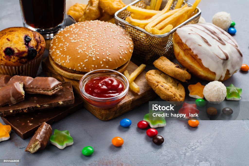 Fast carbohydrates food Assortment of unhealthy products that's bad for figure, skin, heart and teeth. Fast carbohydrates food. Space for text Unhealthy Eating Stock Photo