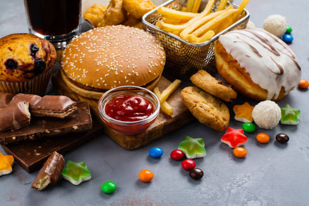 Fast carbohydrates food Assortment of unhealthy products that's bad for figure, skin, heart and teeth. Fast carbohydrates food. Space for text fast food stock pictures, royalty-free photos & images