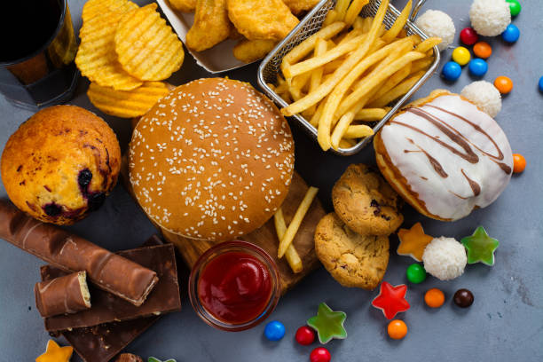 Fast carbohydrates food Assortment of unhealthy products that's bad for figure, skin, heart and teeth. Fast carbohydrates food. Space for text fast food stock pictures, royalty-free photos & images