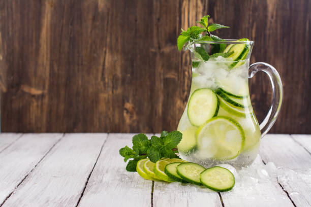 Infused water with cucumber, lime and mint Infused water with cucumber, lime and mint on infused water stock pictures, royalty-free photos & images