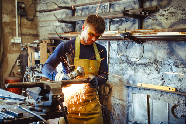 Working saws iron sparks Craftsman sawing metal sparkles all around workshop. Working at noon. grinding metal power work tool stock pictures, royalty-free photos & images