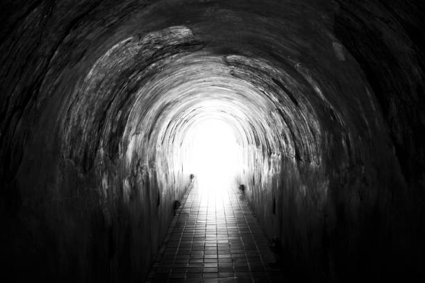 istock Light at the end of the  old tunnel blackWhite 844471520