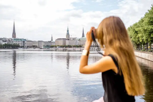 Young woman tourist enjoying great view on the old city centre of Hamburg, Germany