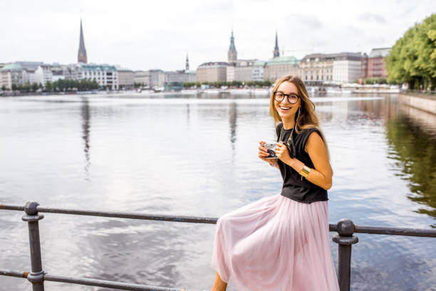 Woman traveling in Hamburg, Germany Young woman tourist enjoying great view on the old city centre of Hamburg, Germany aussenalster lake stock pictures, royalty-free photos & images