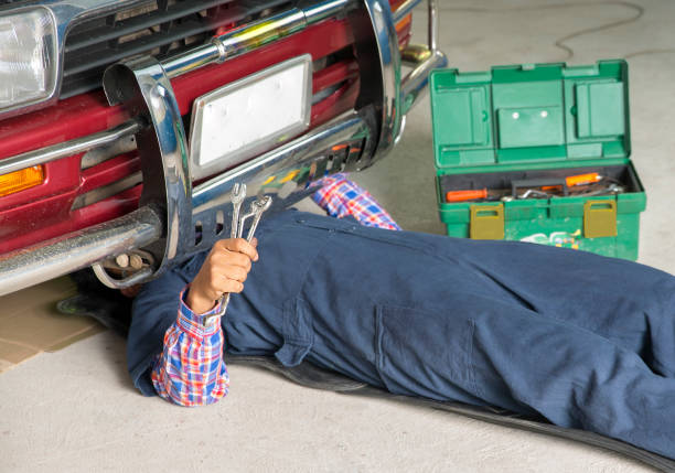 istock Auto mechanic repair engine in a car repair 844477888