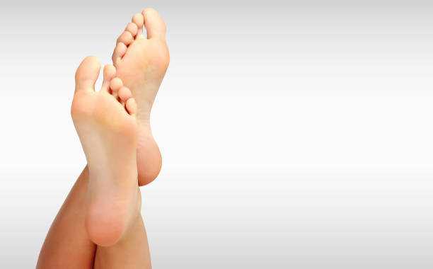istock Beautiful woman's bare feet against a grey background with copyspace 844481726
