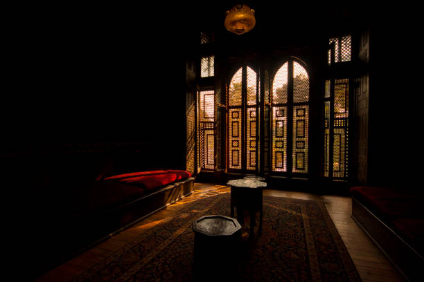 Sneaky Sunlight Rays Sunlight rays entering the room through an old and oriental form of a window called "Mashrabiya". egypt palace stock pictures, royalty-free photos & images