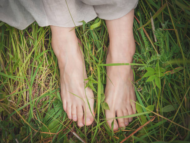 istock Woman legs standing in grass on summer meadow 844485142