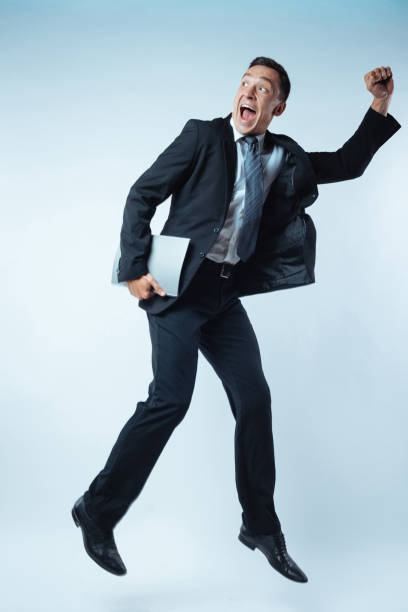 istock Happy joyful businessman jumping from happiness 844488606