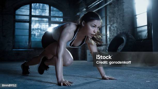 Athletic Beautiful Woman Does Pushups As Part Of Her Cross Fitness Bodybuilding Gym Training Routine Stock Photo - Download Image Now