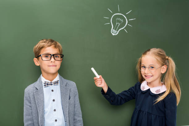 istock beautiful pupils next to chalkboard 844493274
