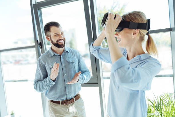 istock Cheerful man giving applause to colleague removing VR headset 844500434