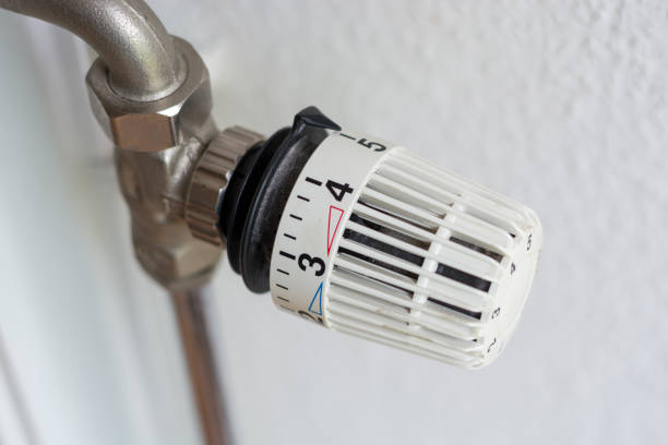 istock White thermostat of a heating set on high from above 844503596