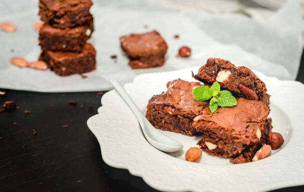 istock Sliced homemade brownies on white plate. Served on rectangle white plate. Favorite chocolate dessert for chocolate lover. Sweet and moist of cocoa taste. Top view 844504884