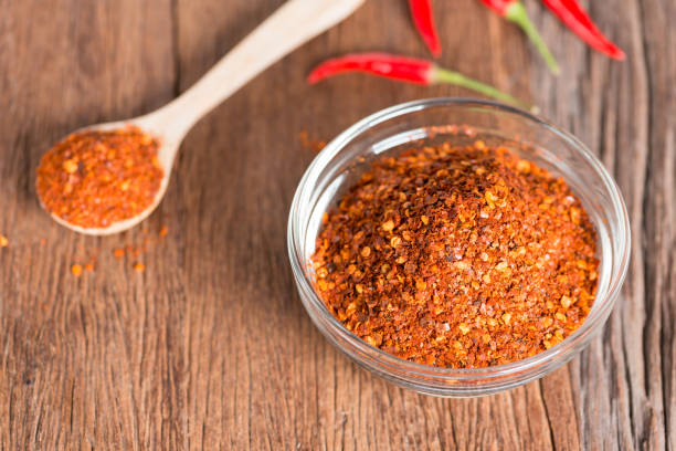 istock Chili powder on wooden background. 844508676