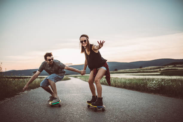 istock Hipster couple riding skateboards 844512158