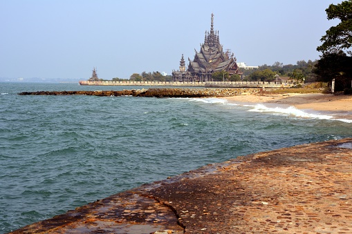 Nakluea beach and the Sanctuary of Truth in the background, an all-wood temple construction filled with sculptures based on traditional Buddhist and Hindu motifs. 

