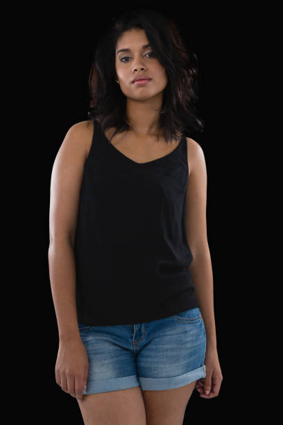 istock Young woman standing against black background 844518724