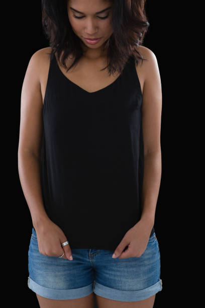 istock Woman stretching tank top against black background 844518764