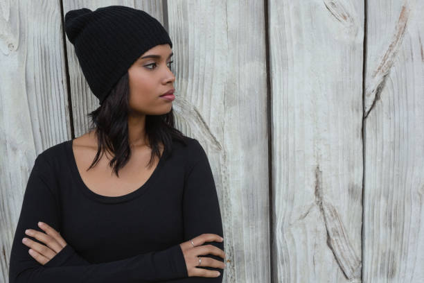 istock Thoughtful young woman standing with arms crossed 844521584
