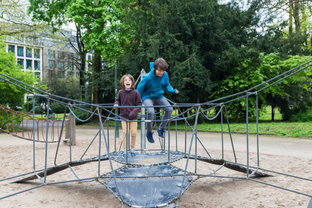 istock Happy children jumping on a trampoline or elastic bed 844522284