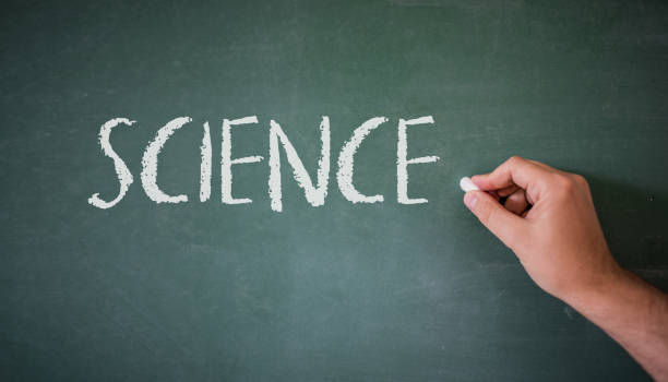 istock A person writing in a blackboard during Science class in a school. 844522688