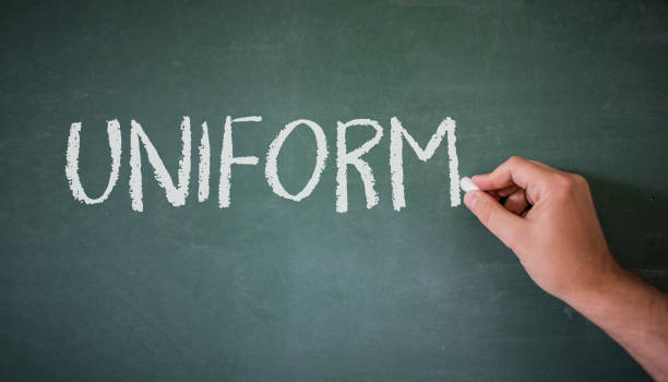 istock The word Uniform hand written on a blackboard. Education concept at school. 844522812