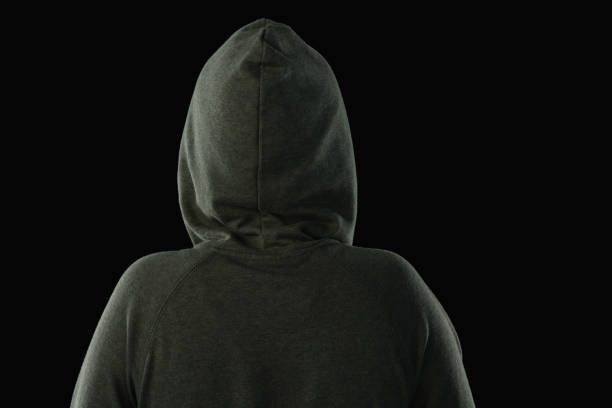istock Woman in hooded jacket against black background 844525936