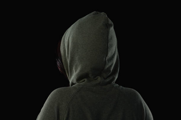 istock Female athlete in hooded jacket against black background 844525968